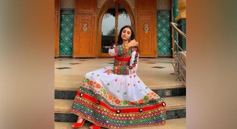 Women share photos of Afghan dresses to protest Taliban's black hijab