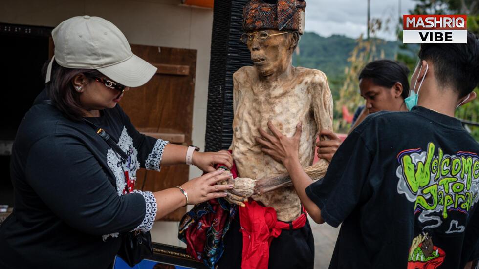 Indonesian villagers dress corpses in ritual for the dead